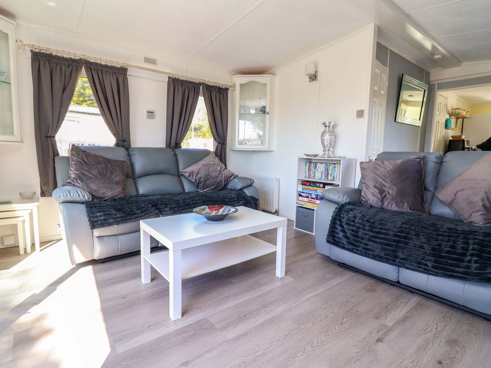 A living room with a sofa and coffee table at Grosvenor 10, Llanarmon-Yn-Ial