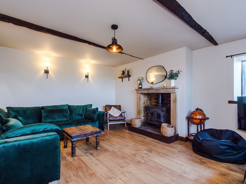 A living room with a fireplace and mirror at Landskill Farm in Preston