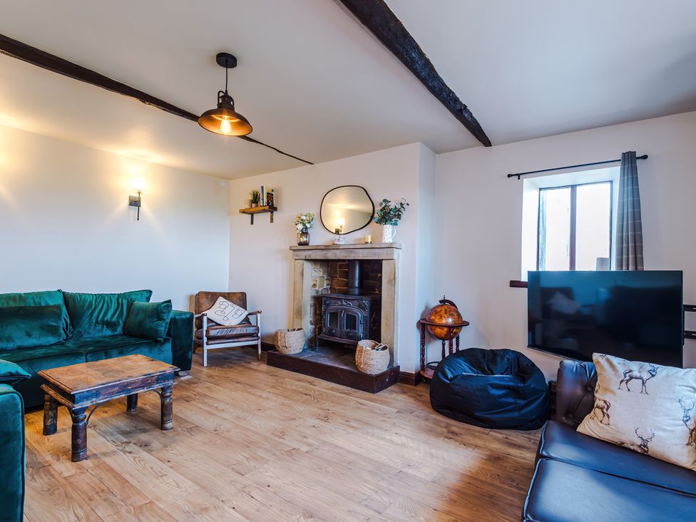A living room with a fireplace and seating area at Landskill Farm in Preston