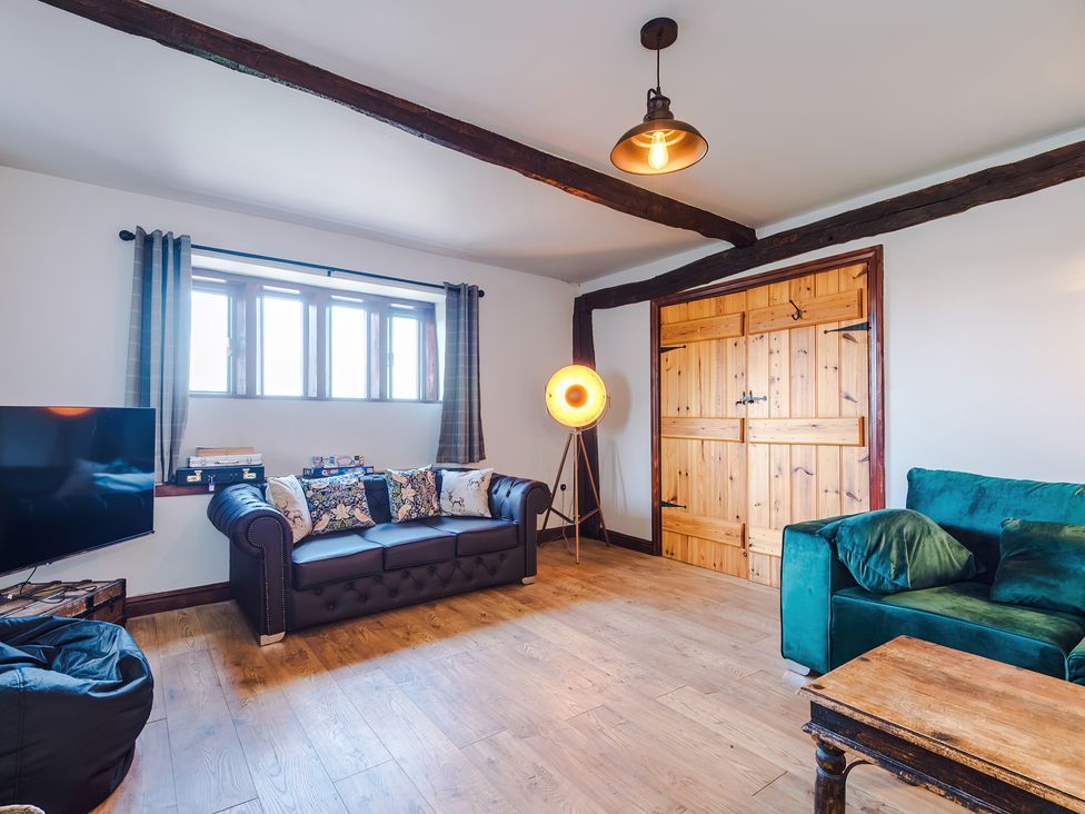 A living room with a sofa and television at Landskill Farm in Preston