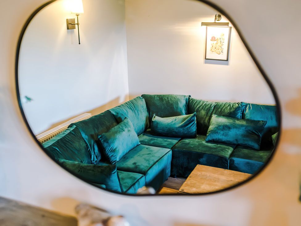 A living room with a green sofa and lamp at Landskill Farm in Preston