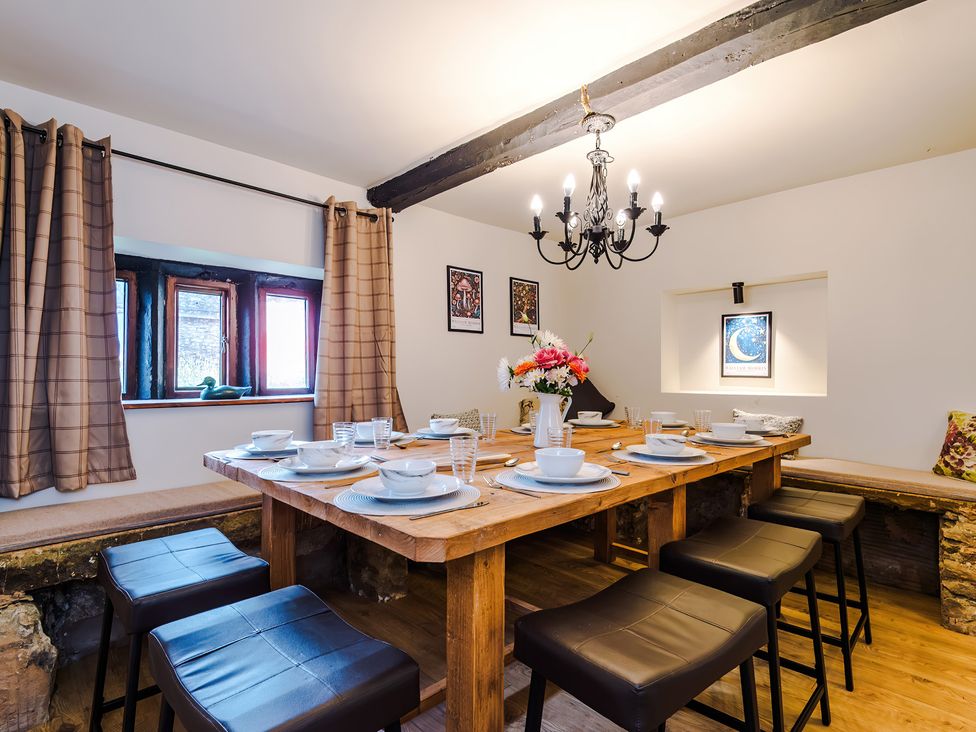 A dining room with a large table set for meals at Landskill Farm in Preston