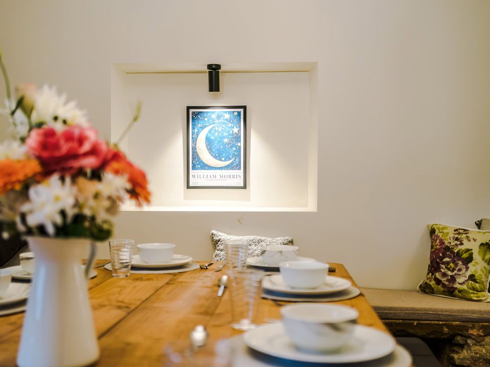 A dining room with a table set for a meal at Landskill Farm in Preston