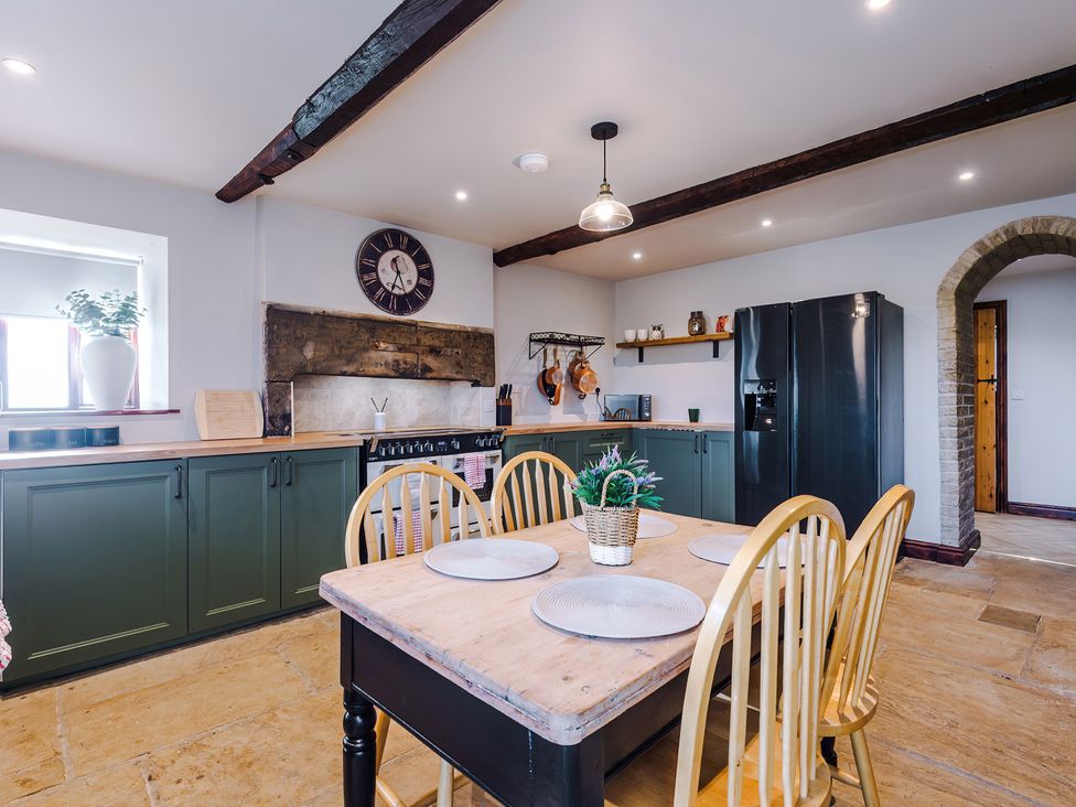 A kitchen with dining table and chairs at Landskill Farm in Preston