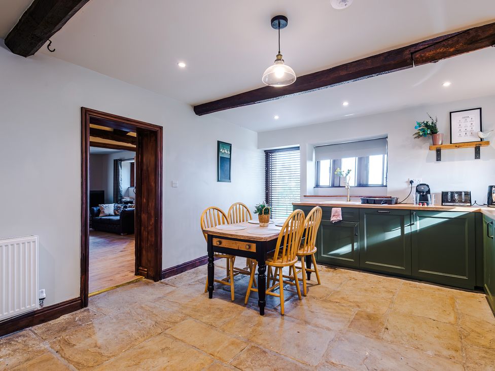 A kitchen with a table and chairs at Landskill Farm Preston
