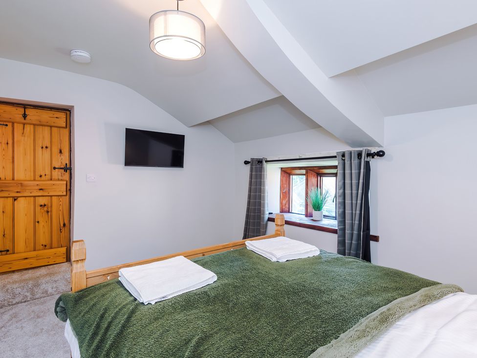 A bedroom with a bed and television at Landskill Farm Preston