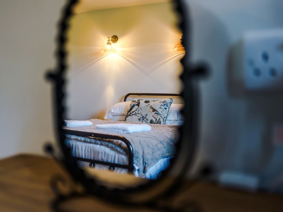 A bedroom with a bed and patterned pillow at Landskill Farm Preston