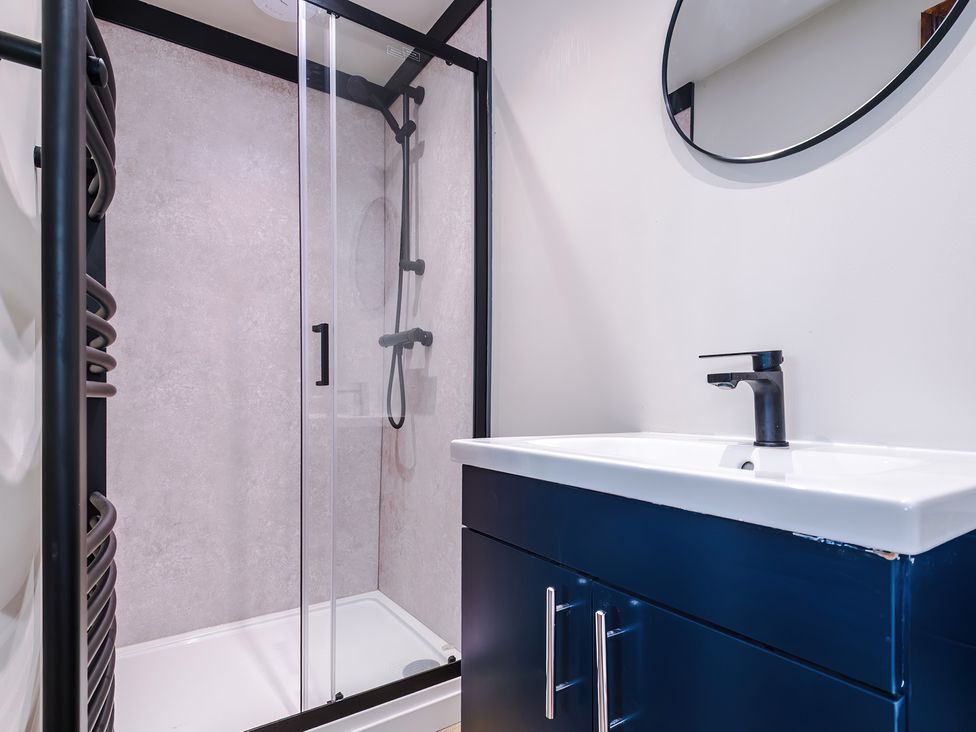 A bathroom with a shower and sink at Landskill Farm in Preston
