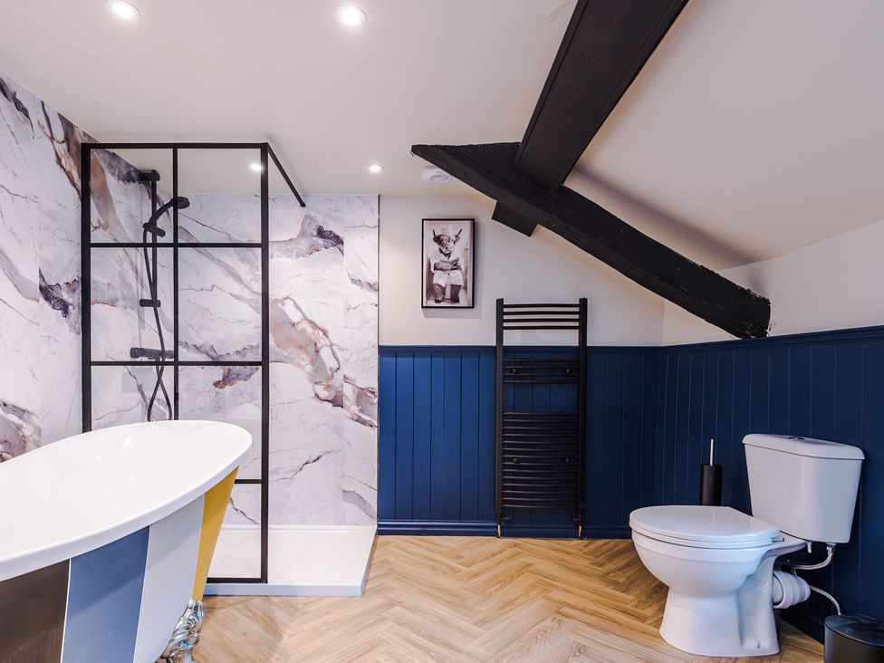 A bathroom with a bathtub and shower at Landskill Farm in Preston