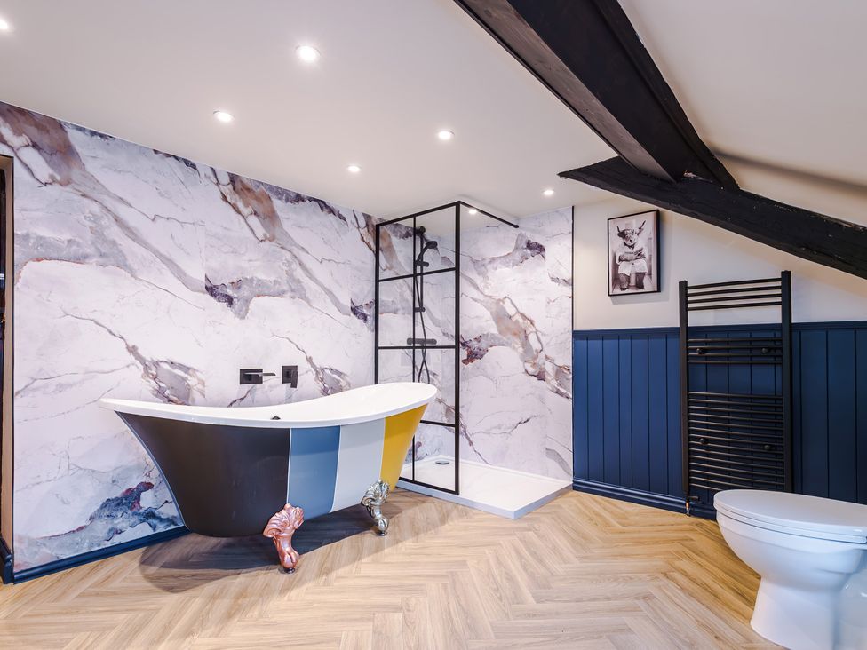 A bathroom with a freestanding bathtub and a shower at Landskill Farm Preston