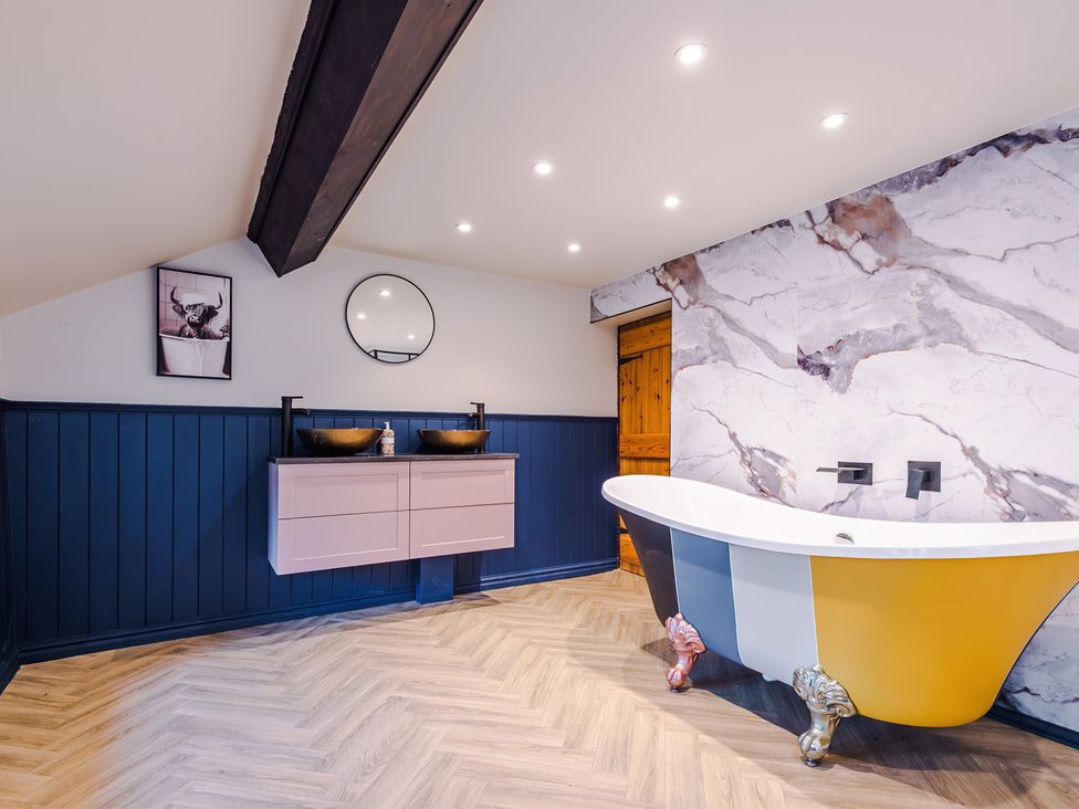 A bathroom with a bathtub and dual sinks at Landskill Farm in Preston