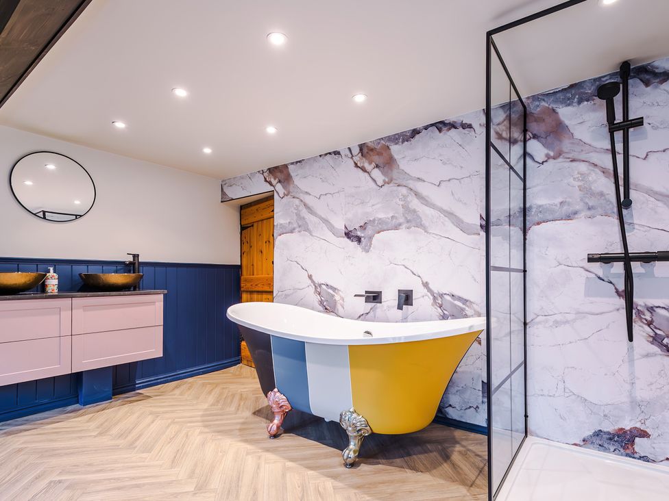 A bathroom with a bathtub and sinks at Landskill Farm in Preston