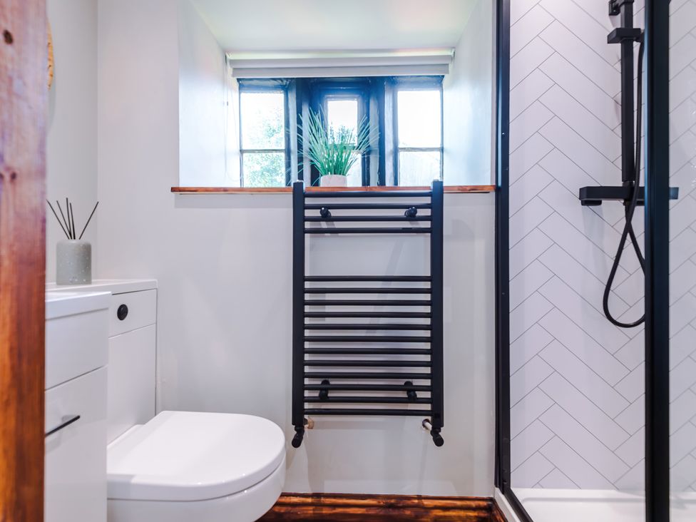 A bathroom with a shower and toilet at Landskill Farm in Preston
