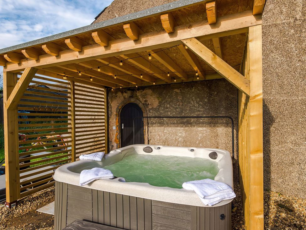 A hot tub with towels in an outdoor area at Landskill Farm Preston