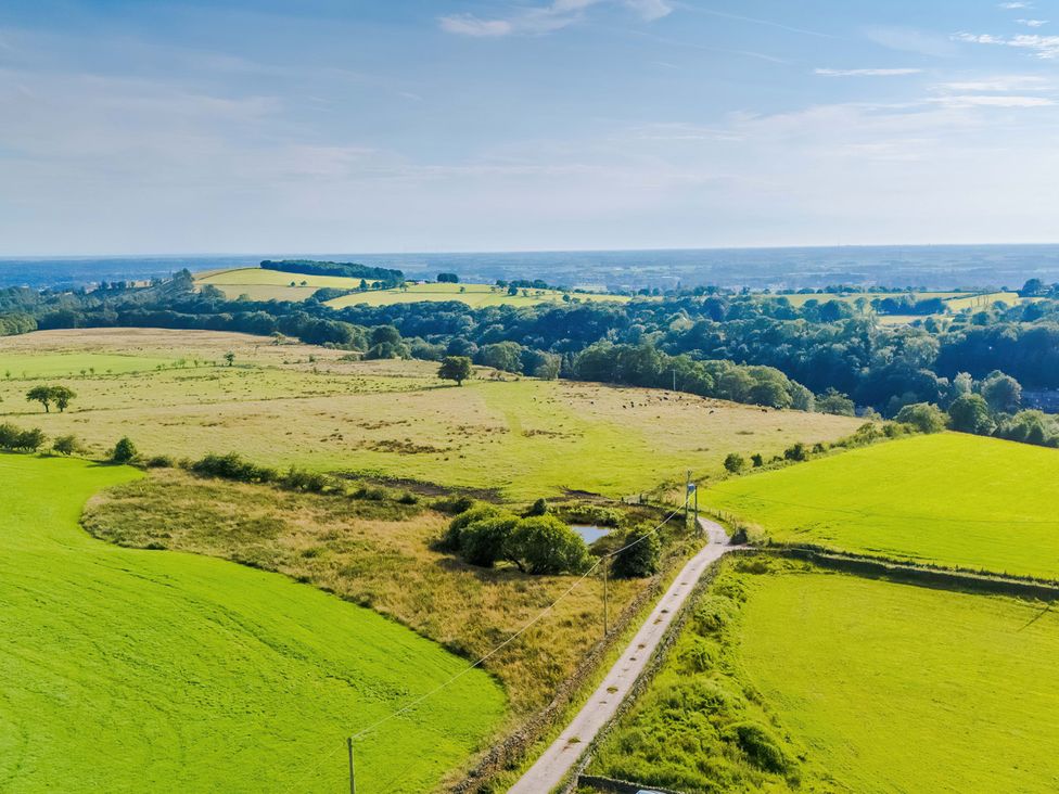 A panoramic view of fields and a road at Landskill Farm in Preston