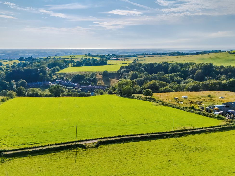 An aerial view of fields and trees at Landskill Farm in Preston