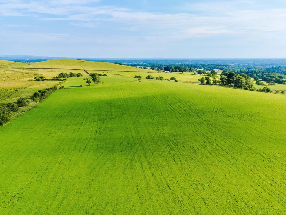An expanse of green fields and hills at Landskill Farm in Preston