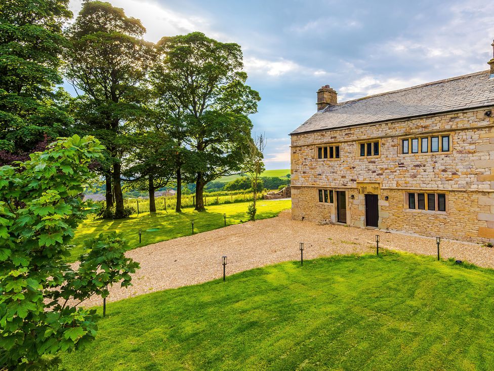 A house with trees and a gravel pathway at Landskill Farm Preston