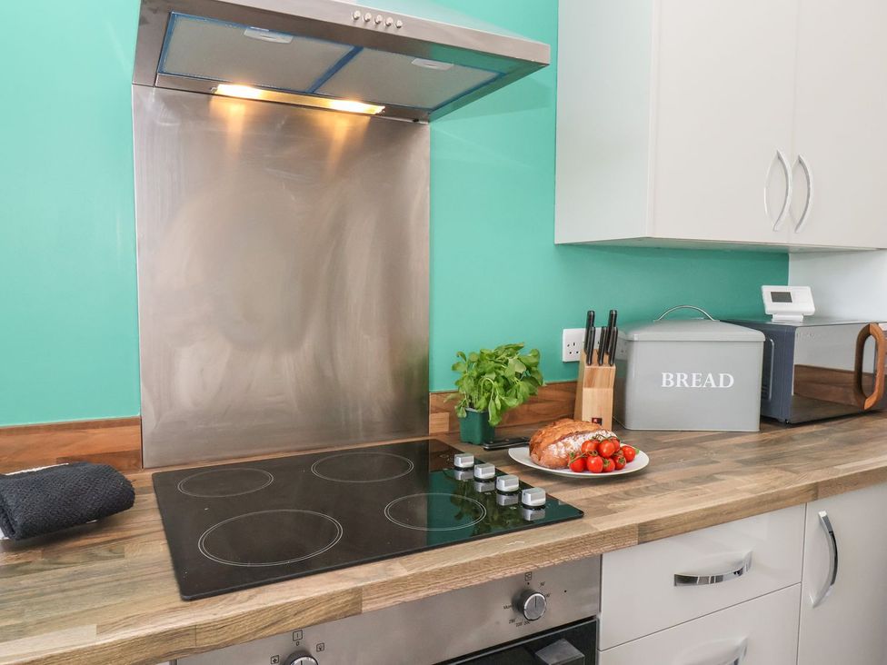 A kitchen with stove and extractor fan at Frankie’s Seaview 1 in Bridlington