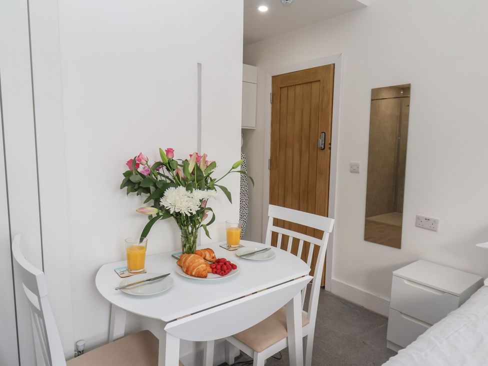 A dining area with a table and chairs at Frankie’s Seaview 1 in Bridlington