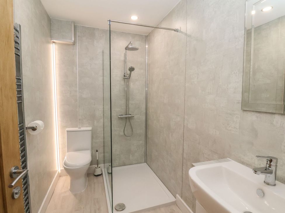A bathroom featuring a shower, toilet, and sink at Frankie’s Seaview 1 in Bridlington