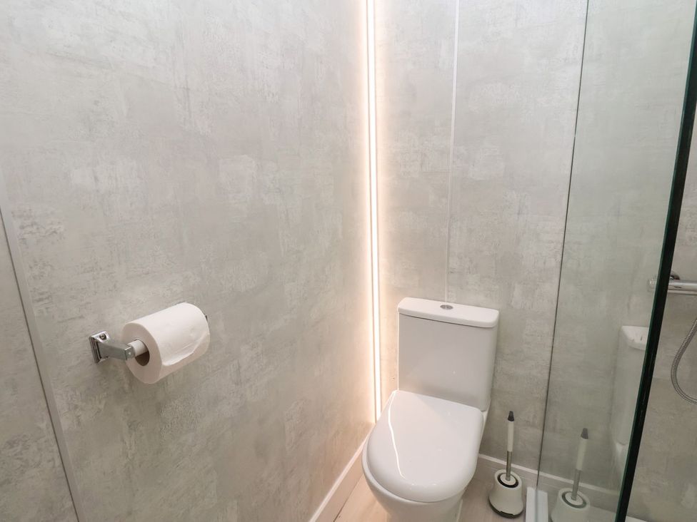 A bathroom featuring a toilet and toilet paper holder at Frankie’s Seaview 1 in Bridlington