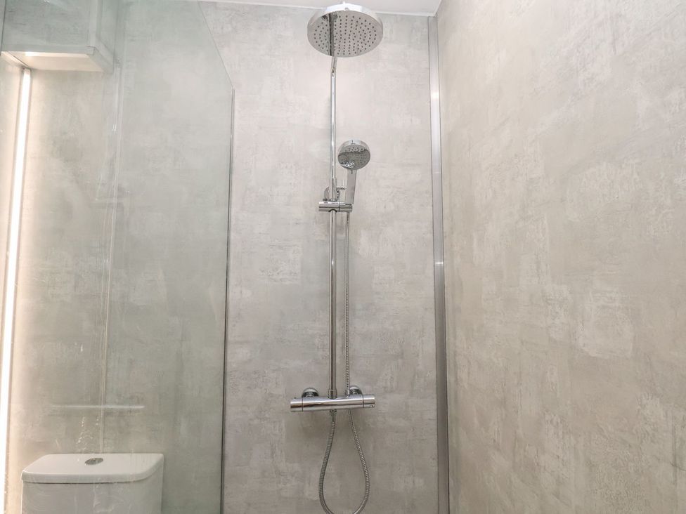 A bathroom with a shower and toilet at Frankie’s Seaview 1 in Bridlington