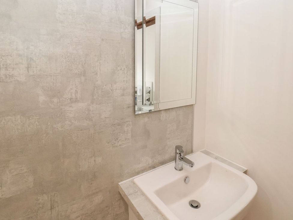 A bathroom with a sink and mirror at Frankie’s Seaview 1 in Bridlington