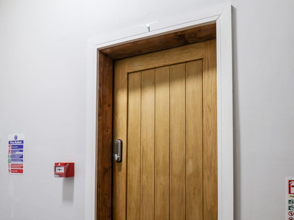 A door with a keypad in a hallway at Frankie’s Seaview 1 Bridlington