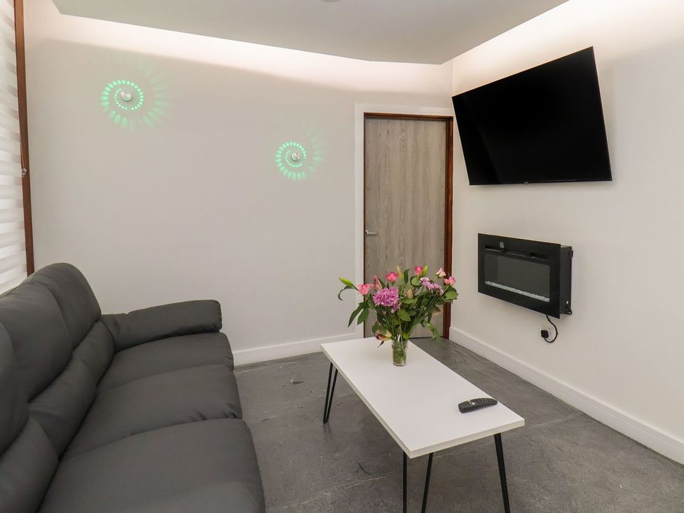 A living room with a sofa and a table at Frankie’s Seaview 2 in Bridlington
