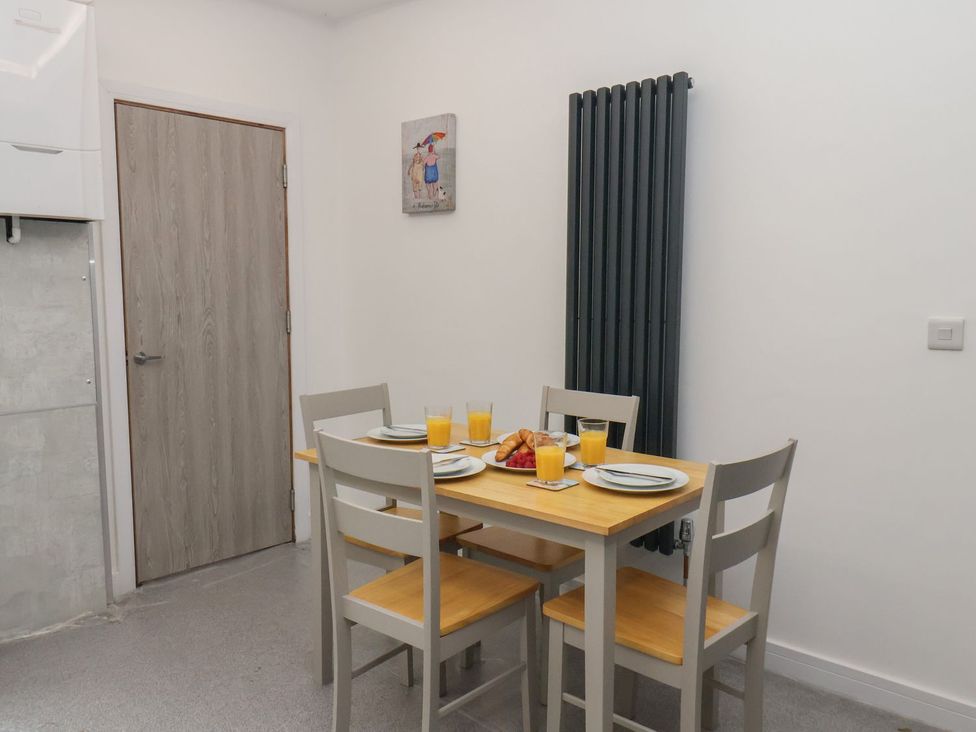 A dining room with a table and chairs at Frankie’s Seaview 2 in Bridlington