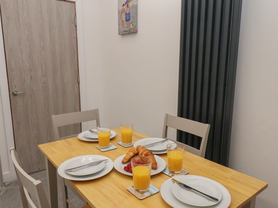 A dining room with a table set for breakfast at Frankie’s Seaview 2 in Bridlington