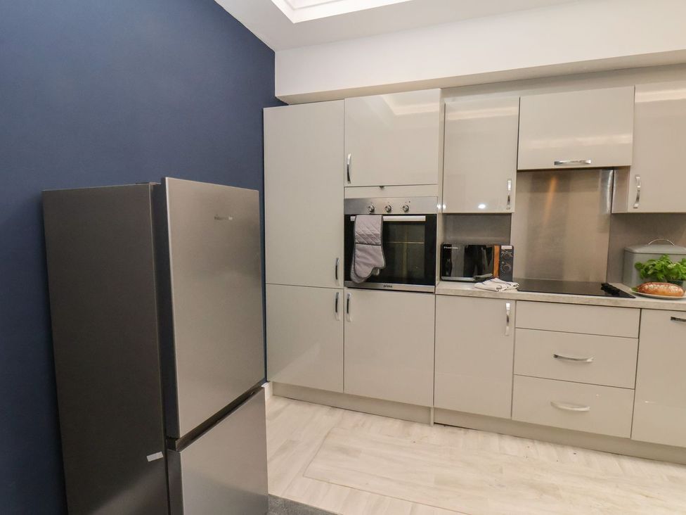 A kitchen with a refrigerator and oven at Frankie’s Seaview 2 in Bridlington