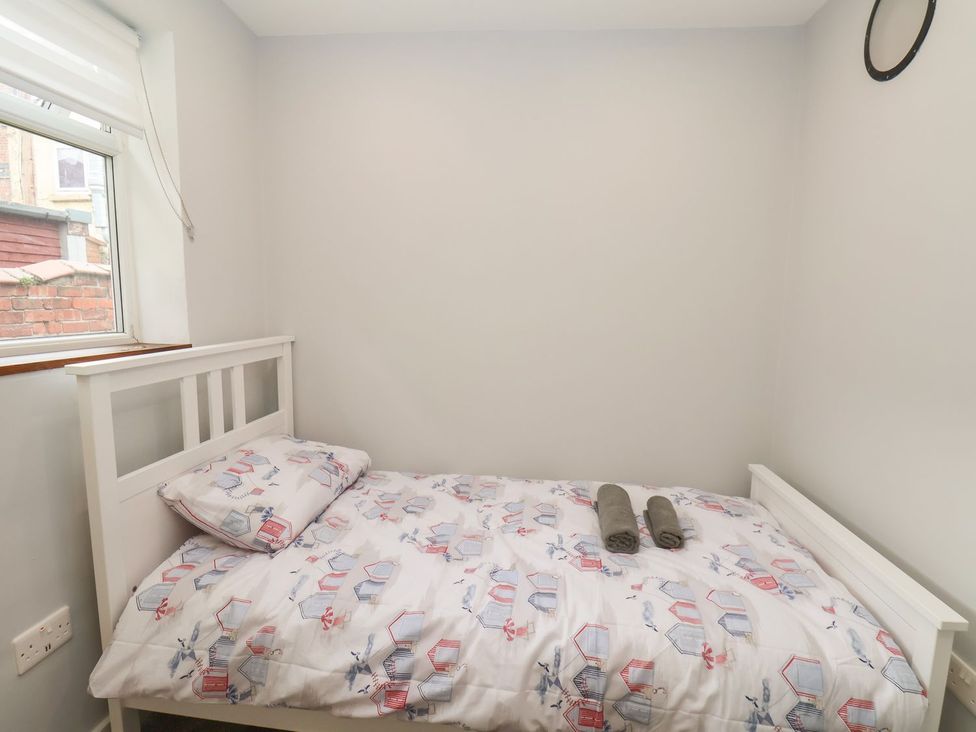 A bedroom with a bed and towels at Frankie’s Seaview 2 in Bridlington