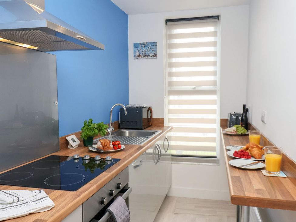A kitchen with a stove and sink at Frankie’s Seaview 4 in Bridlington