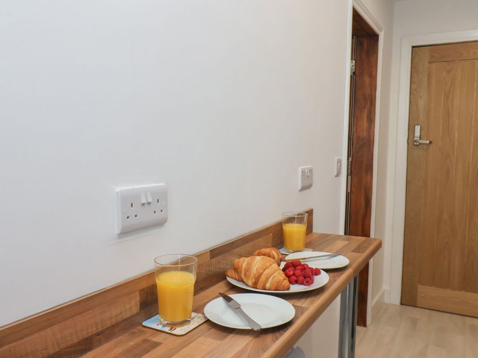 A countertop with orange juice, croissant, and raspberries at Frankie’s Seaview 4 in Bridlington