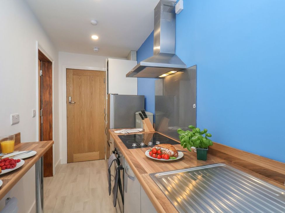 A kitchen with a refrigerator and stove at Frankie’s Seaview 4 in Bridlington