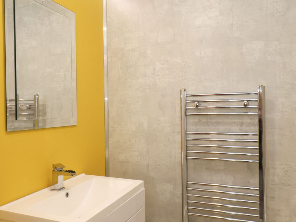 A bathroom with a sink and mirror at Frankie’s Seaview 4 in Bridlington