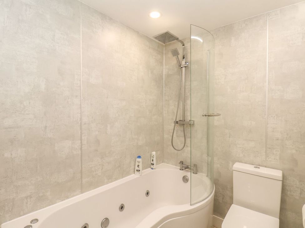 A bathroom with a bathtub and shower at Frankie’s Seaview 4 in Bridlington