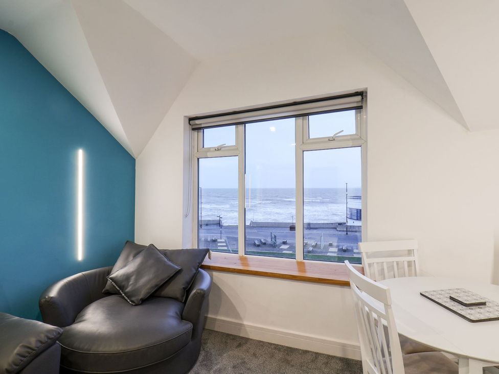 A living room with a window overlooking the sea at Frankie’s Seaview 5 in Bridlington