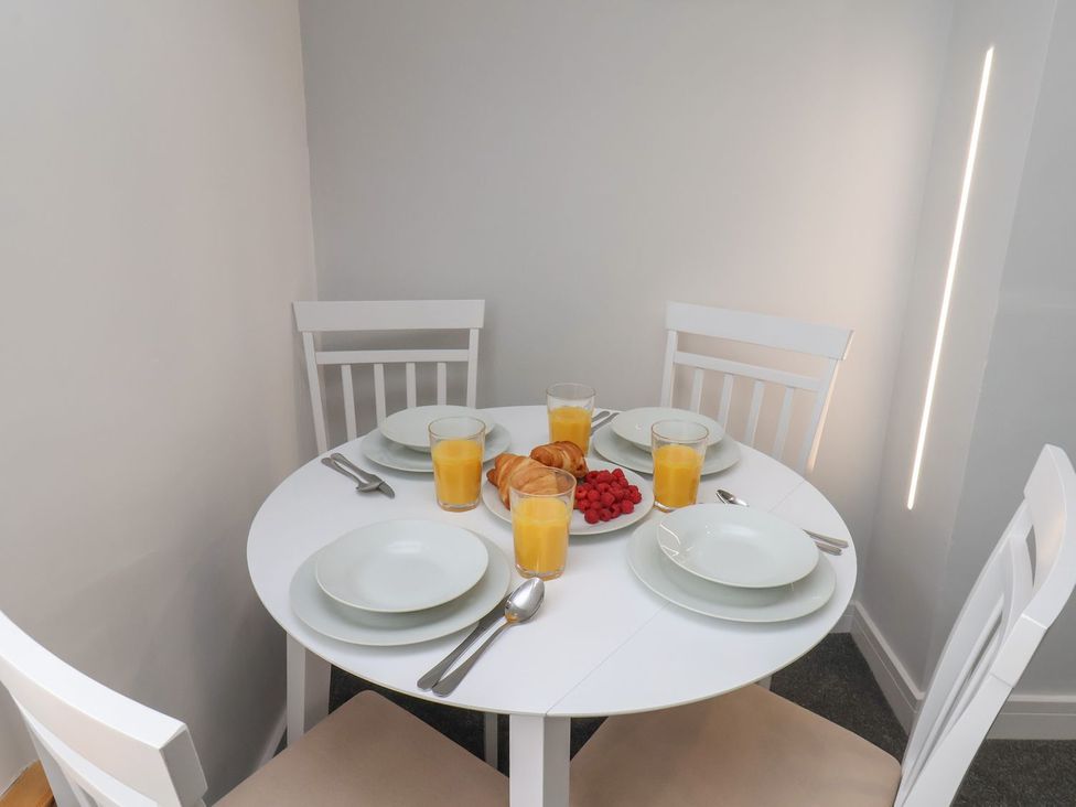 A dining room table set with plates and drinks at Frankie’s Seaview 5 in Bridlington