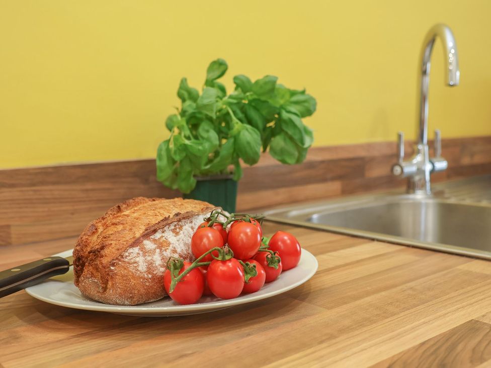 A kitchen counter with bread and tomatoes at Frankie’s Seaview 5 in Bridlington