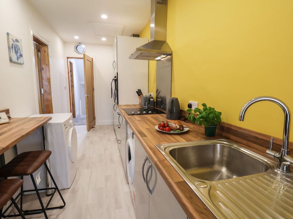 A kitchen with a sink and stove at Frankie’s Seaview 5 in Bridlington