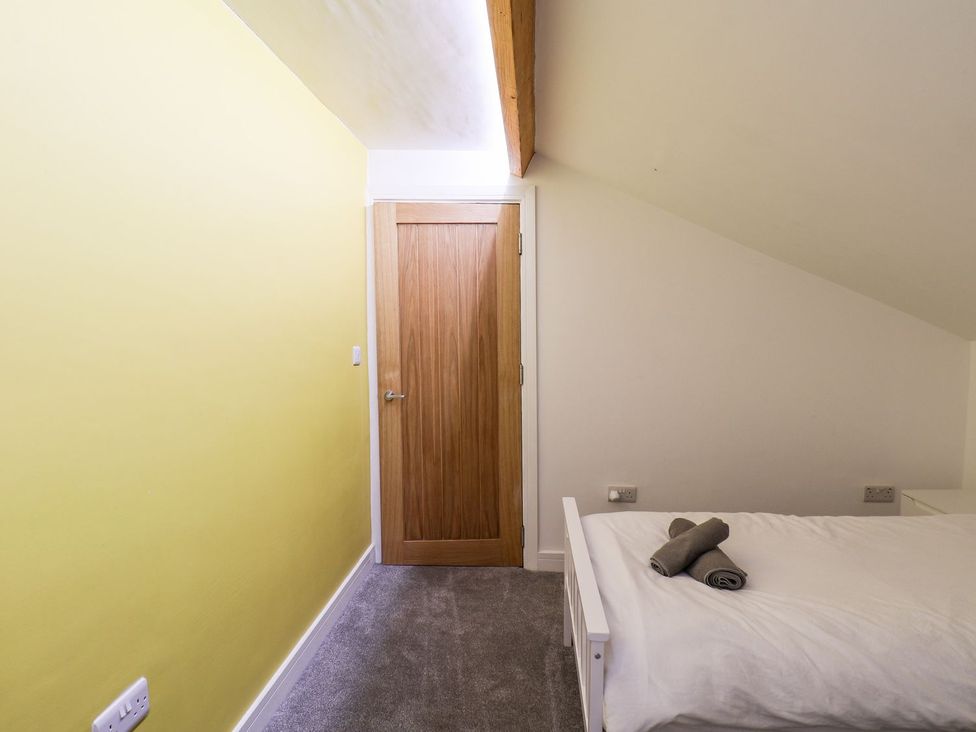A bedroom with a bed and door at Frankie’s Seaview 5 in Bridlington