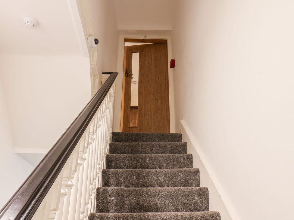 A staircase leading to a door at Frankie’s Seaview 5 in Bridlington
