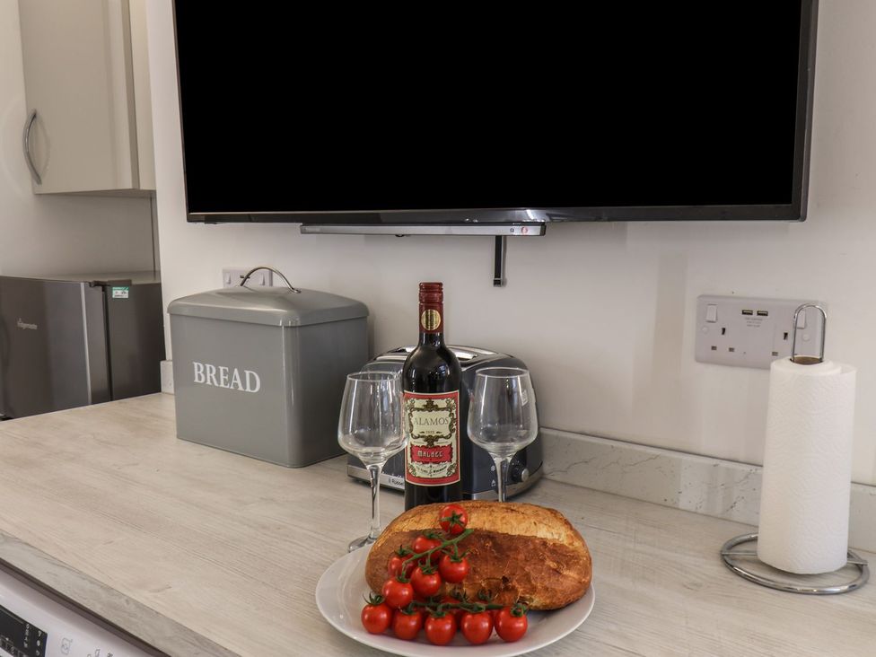 A kitchen with a toaster and wine on the counter at Frankie’s Seaview 3 in Bridlington