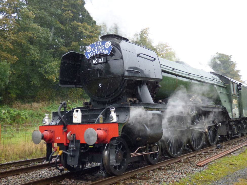 A steam locomotive with smoke at The Flying Scotsman in Keighley