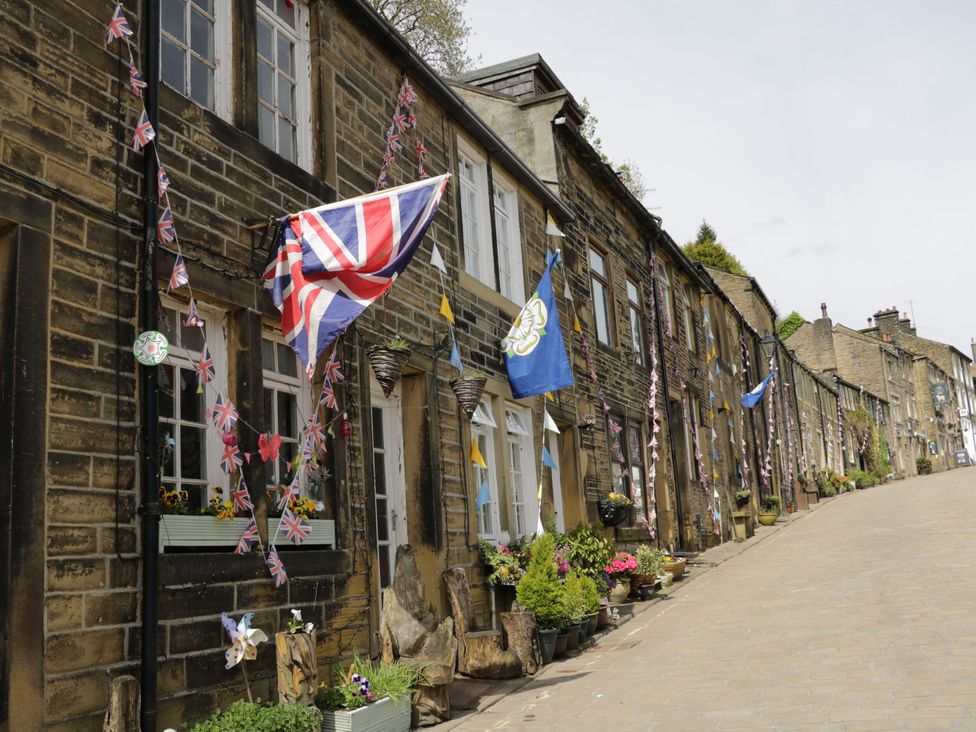 A street lined with decorated buildings at Milburn Cottage in Keighley