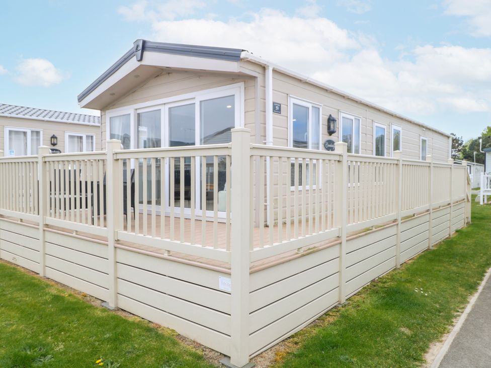 An outdoor view of a mobile home with a deck at 59 Cliff Field Lowestoft
