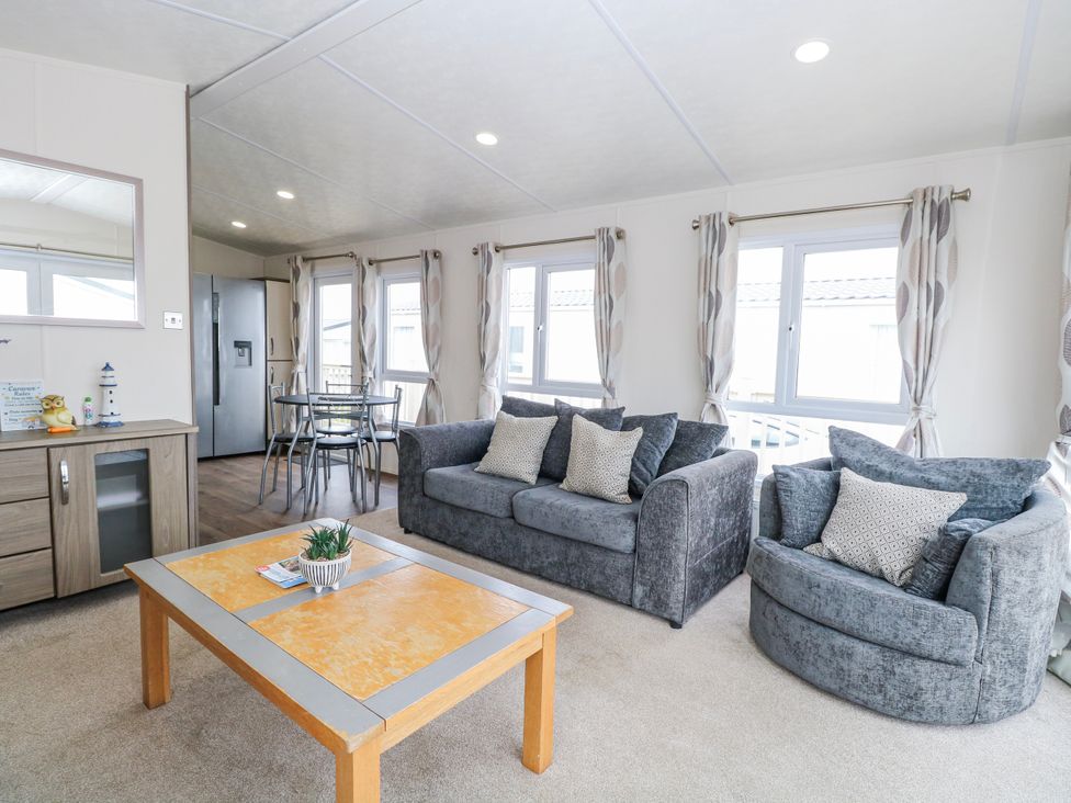 A living room with seating and a coffee table at 59 Cliff Field in Lowestoft